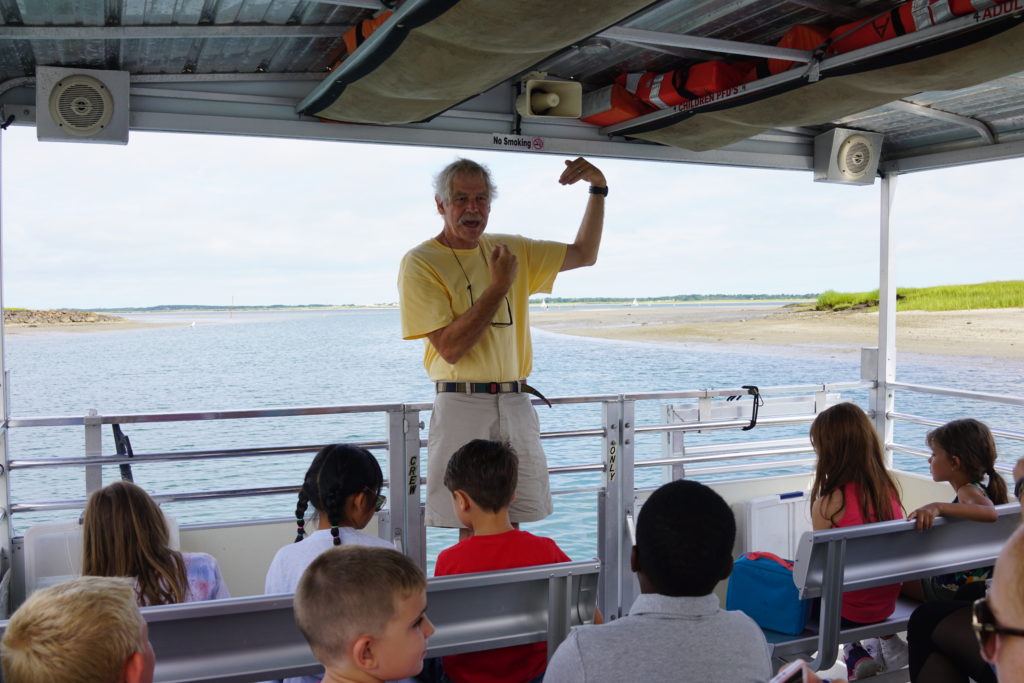 I am the environmental guy aboard Barnstable Harbor Ecotours bending my arm in the shape of Cape Cod